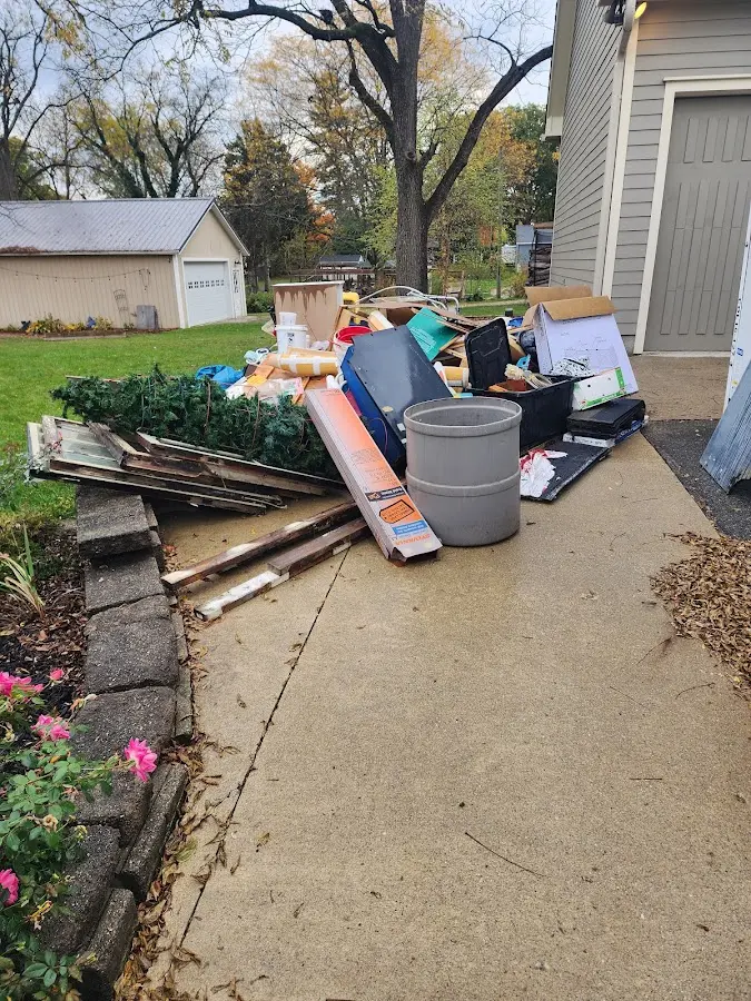 Dumpster being loaded with debris for Roofing Dumpster Rental in Holts Summit